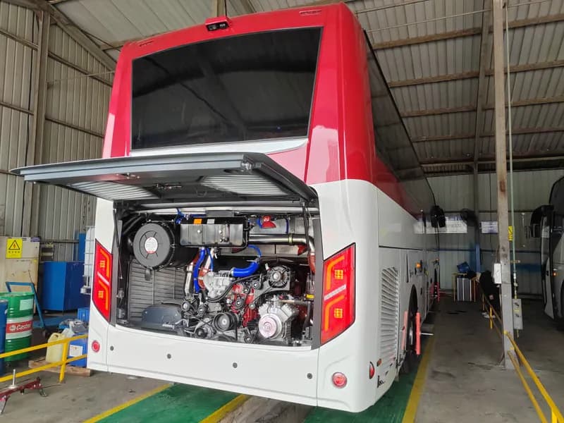 Rear view with engine bay open in maintenance workshop