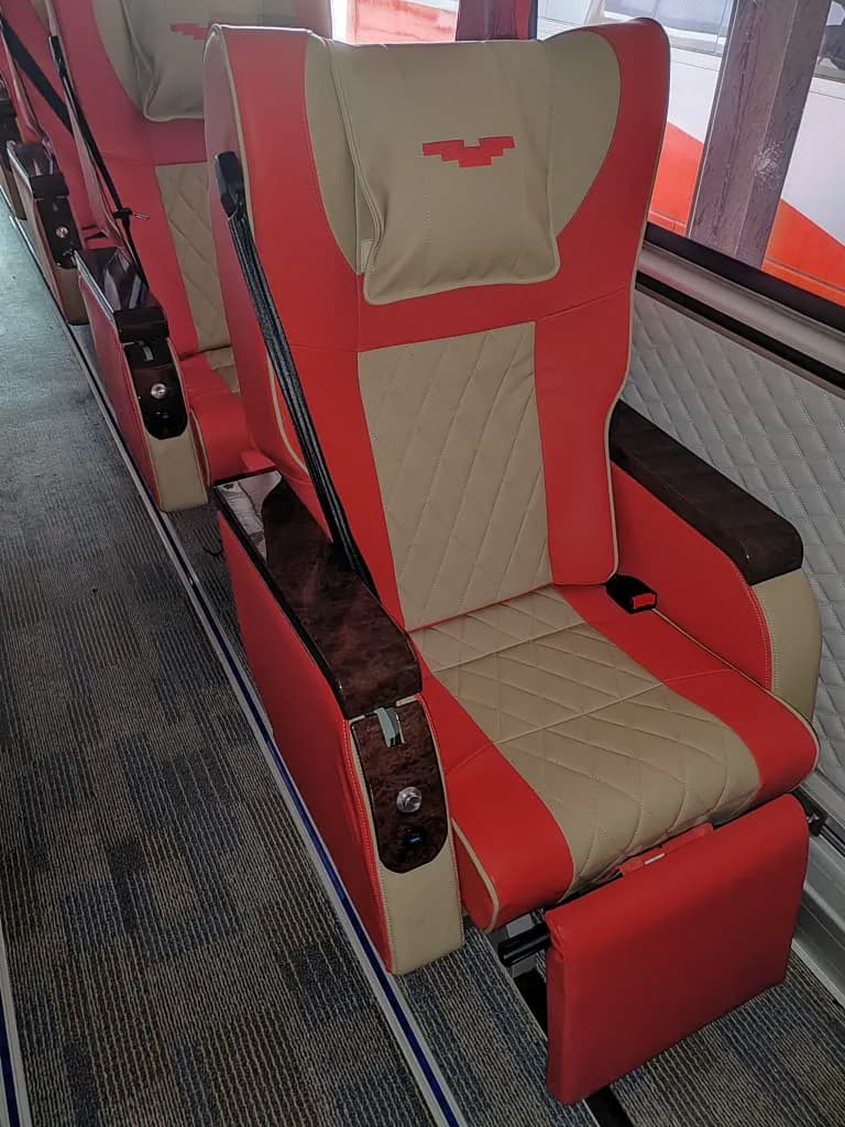 Passenger seat / window detail — red & beige interior